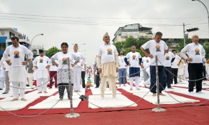 Prime Minister KP Sharma Oli (centre) and his wife Radhika Shakya (second from left) including Deputy Prime Ministers, lawmakers and high level officials practise yoga at a programme jointly organised by Government and IYD Main Organising Committee to mark the International Yoga Day, at Durbar Marg in Kathmandu on Tuesday, June 21, 2016. PHOTO: Balkrishna Thapa Chhetri/THT